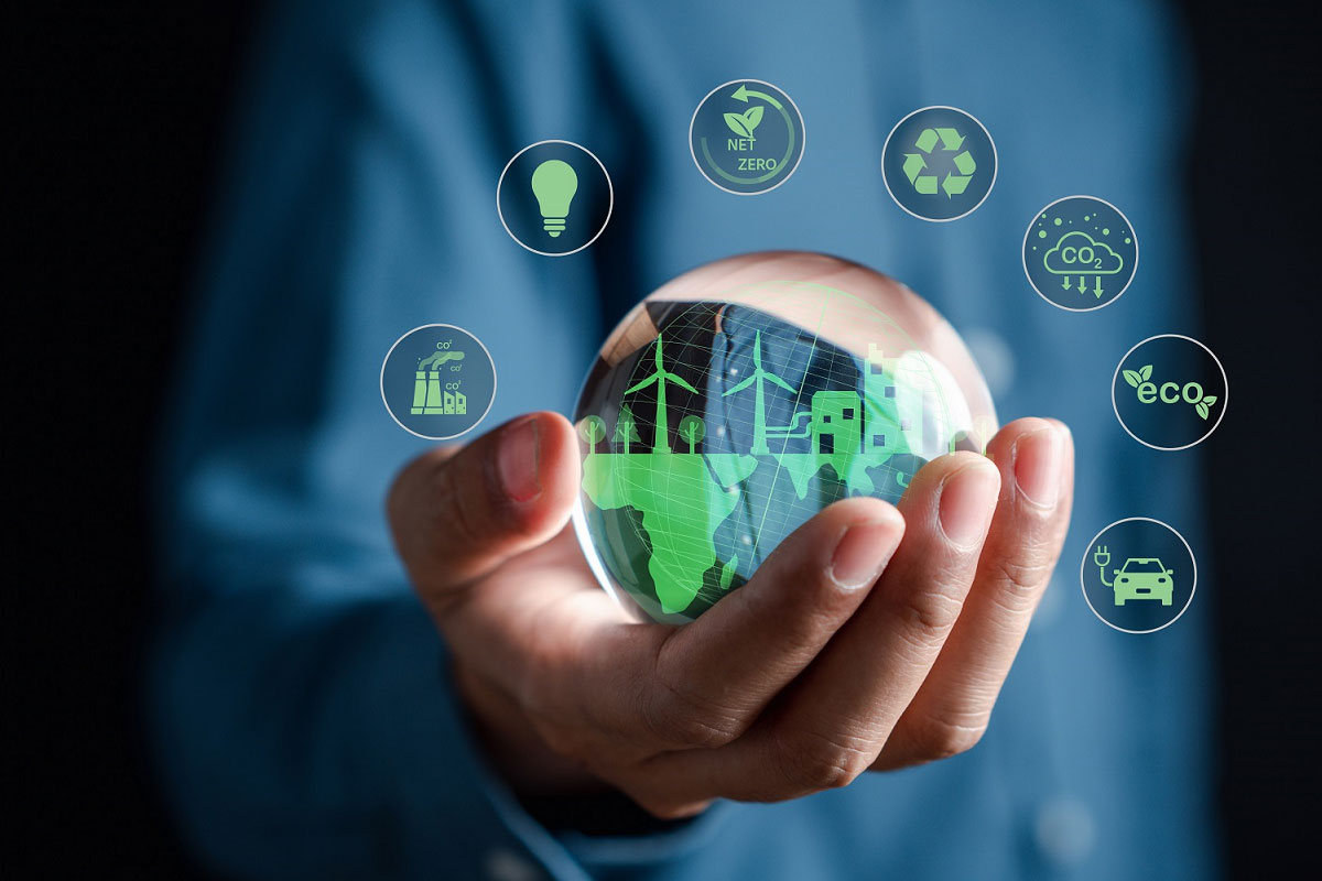 Hand holding a globe surrounded by icons